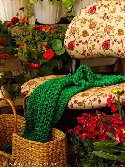 As the weather changes, so do my projects. This lush green throw, draped over a chair, is ready for the cooler days ahead.