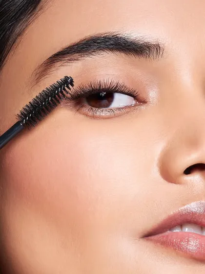 A detailed macro shot of mascara being applied to the lashes. This image represents my meticulous attention to detail, ensuring every element of the makeup, down to the last lash, is perfectly defined and flawlessly executed.