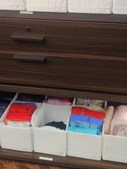 Here is another example of using fabric organizers on shelves. They are perfect for storing smaller items like undergarments, socks, or activewear, keeping them contained and tidy.