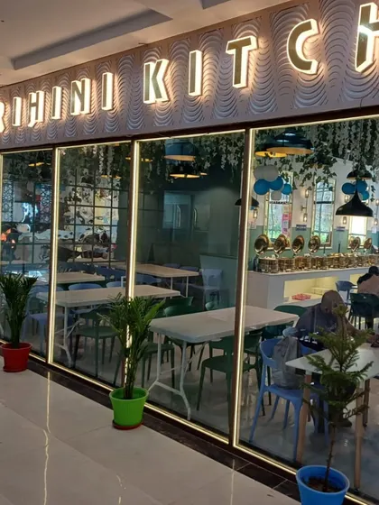The storefront of our restaurant, with the "Grihini Kitchen" sign brightly lit. A welcoming entrance for all our guests.