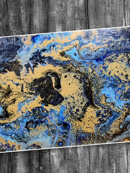 A fluid art painting featuring a striking combination of blue, black, and gold. Learn how to control the paint flow to create captivating patterns and cells.