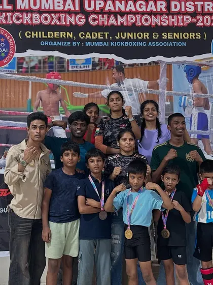 The whole team, including senior athletes and coaches, celebrating a massive victory at the All Mumbai Kickboxing Championship. It takes a village to raise a champion.