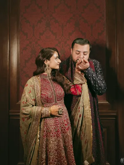 A romantic gesture. This sweet moment captures the love and connection between the couple on their special night.