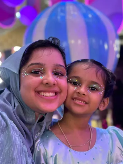 Twinning is winning. A mother and daughter duo showing off their matching glitter eye makeup.