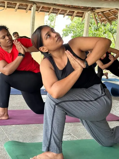 A duplicate of ID 72, showing students in Parivrtta Anjaneyasana (Revolved Lunge Pose) during a retreat. This image captures the shared experience and supportive atmosphere of our community events.