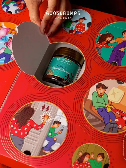 The 'Nok Jhok' box is full of hidden gems. In this shot, a jar of Coffee Almond Dragees is discovered, ready to be enjoyed while reminiscing about old times.