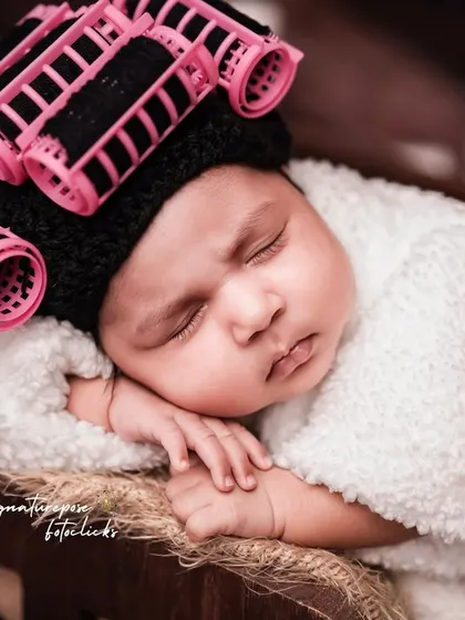 Another adorable pose from the newborn spa day session, showcasing the tiny details and the humor of the theme.