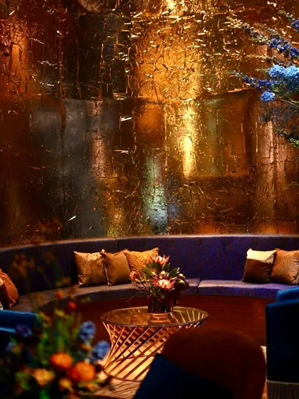 A detail of the textured, hand-finished gold foil walls that created a sense of aged luxury in the lounge alcoves.