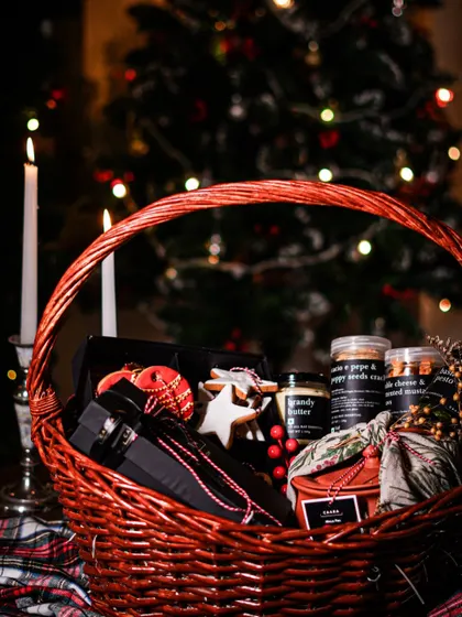 The warmth of Christmas, captured in a basket. This festive hamper is filled with holiday cheer, featuring our classic Christmas treats, pantry essentials like our brandy butter, and other gourmet surprises, all nestled in a rustic red wicker basket perfect for the season.