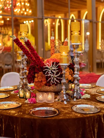 The full view of the traditional centerpiece, set on a luxurious velvet tablecloth. The combination of silver, gold, and a fiery color palette creates a look of regal opulence.