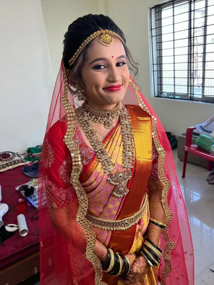 The joy on my bride Sanjana's face is priceless. Her Muhurtham look was all about classic elegance with a beautiful red and gold saree and traditional jewelry.