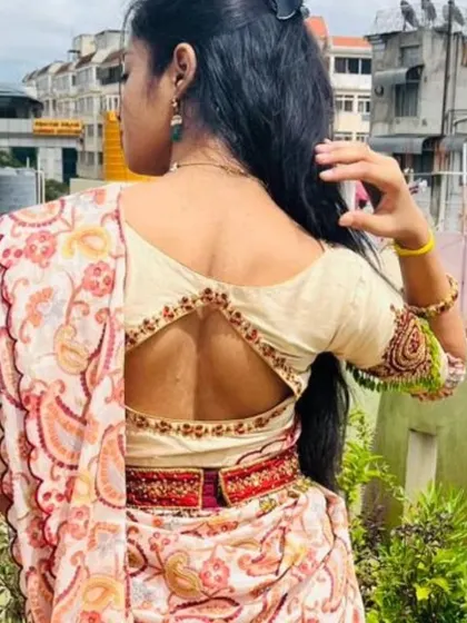 The back view of a beautiful hand-embroidered lehenga set. The blouse has a unique cut-out design.