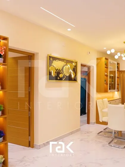This space combines dining and prayer areas, featuring a custom pooja unit with intricate detailing and warm backlighting. The design ensures a harmonious flow between different functional zones in the home.