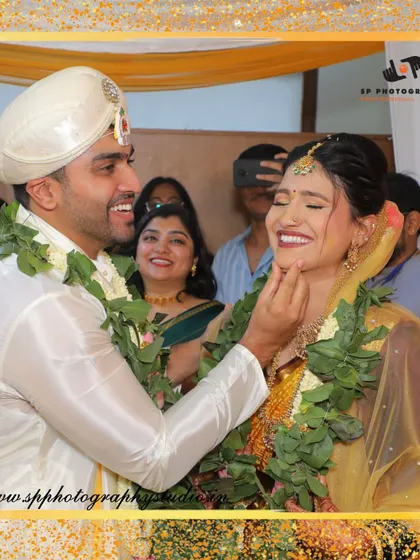 A candid moment of pure happiness. The groom's gentle touch and the bride's radiant smile say it all, captured naturally without any posing.