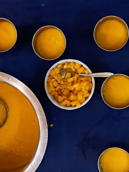 The finished product: creamy mango milkshake ready to be served. The children get to see the process from whole fruit to delicious drink, learning about transformation and enjoying the results.