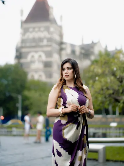 A candid, thoughtful portrait. The blurred background of the historic building adds a sense of place without distracting from the subject.