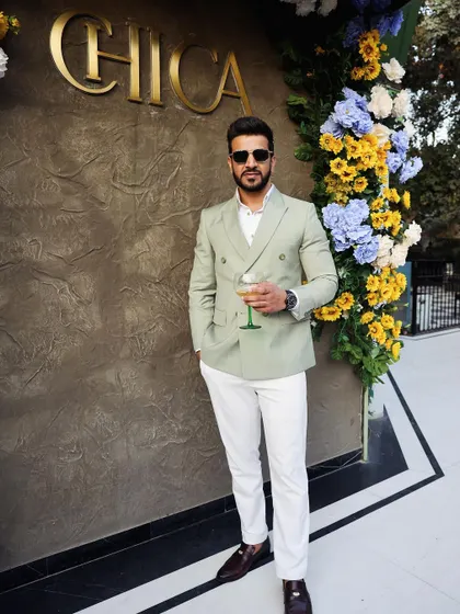 A perfect look for a daytime event or stylish brunch. This client wears a custom light green double-breasted suit, paired with white trousers for a fresh, sophisticated ensemble.