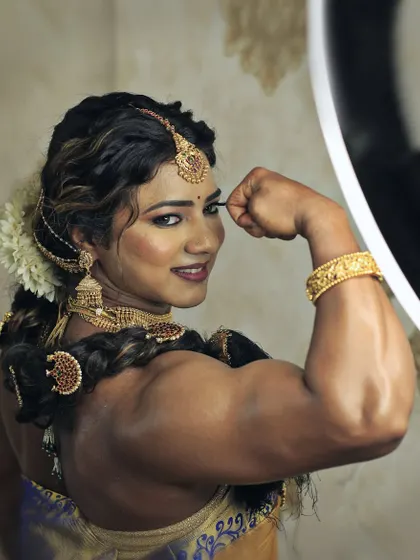A close-up of the result of dedication. Flexing in full traditional wear, I am redefining what it means to be a strong woman.