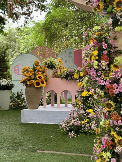 A beautiful floral installation using sunflowers and other colorful blooms.