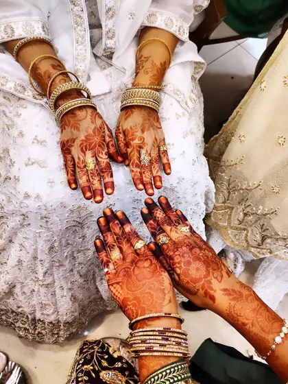 Another shot of two clients with their beautifully stained hands, adorned with rings and bangles.