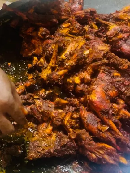 A close-up of our chicken being prepared on a large tawa. This is part of our live cooking service, where guests can see their food being made fresh, adding to the event's atmosphere.