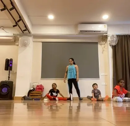 Every class starts with a proper warm-up and stretching. Here, an instructor guides the students to prepare their bodies for dancing safely.