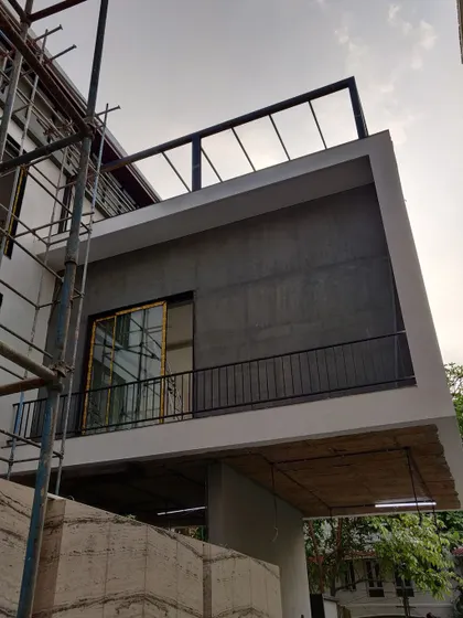 A duplicate image of a residential facade during construction.