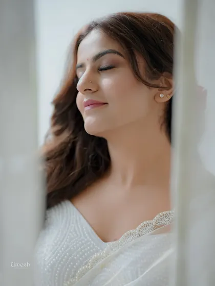 A beautiful close-up with eyes closed, showing the subtle and clean eye makeup. This is a perfect example of a 'no-makeup' makeup look for photoshoots.