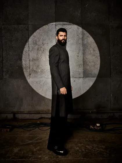A side profile of Vijay's Anamika Khanna look, emphasizing the long, clean lines of the garment.