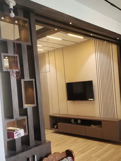 A close-up of the geometric wooden partition, which adds visual interest while separating the entryway from the main living space.