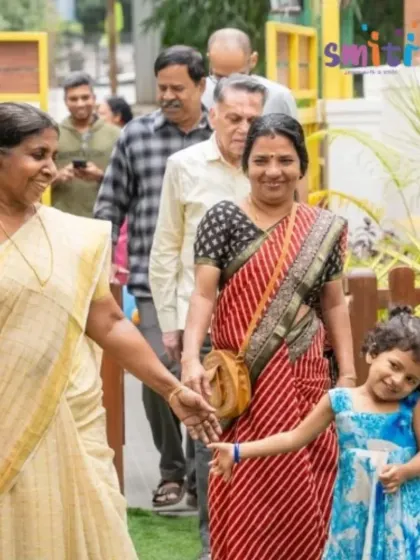 A little girl proudly leads her grandmothers into the school. The event is a celebration of family bonds and shared love.