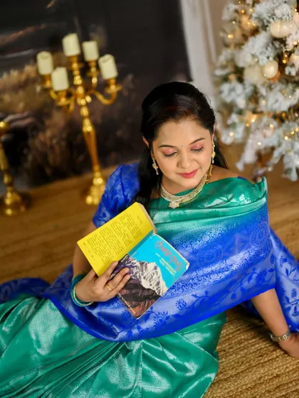 A quiet moment from a traditional saree shoot in the studio. The classic painted backdrop and props create a very serene and artistic feel.
