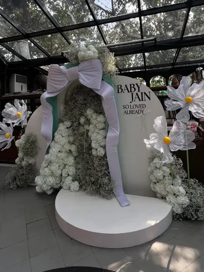 A wider shot of the giant bow backdrop, showing its scale and how it creates a stunning focal point in the venue.