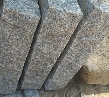 A stack of freshly cut, rectangular stone pillars.