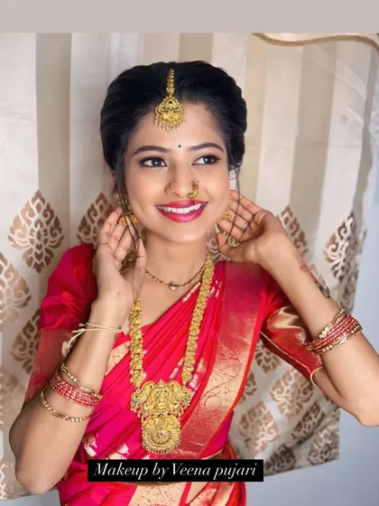 A joyful bride ready for her ceremony. The makeup is bright and celebratory, with a focus on radiant skin and a happy smile.