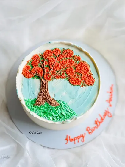 This cake is a tribute to the beautiful Gulmohar tree. The design is hand-piped with colored buttercream to create a miniature painting you can eat.