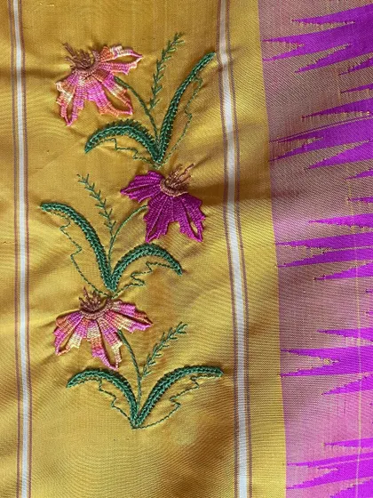 Another detail of the custom Kamal Kadai work, showing the delicate floral vine. I carefully select thread colors to complement the saree's base, ensuring the embroidery enhances the beauty of the original textile.