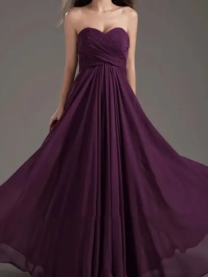 This simple and elegant purple chiffon gown features a strapless, sweetheart neckline and a flowing skirt.