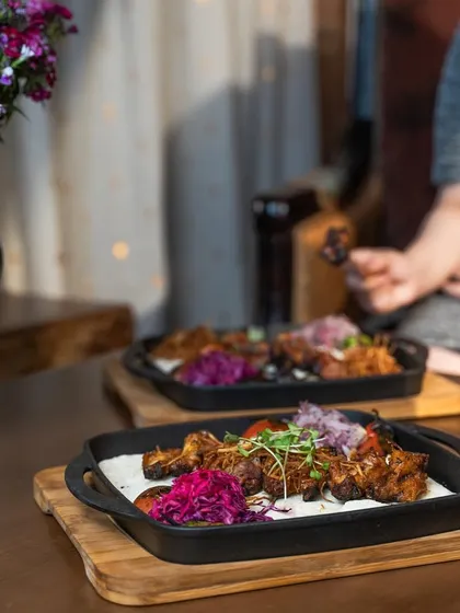 Another look at our sizzling Turkish-style chicken wings, served with traditional accompaniments for a luxurious and indulgent bite.