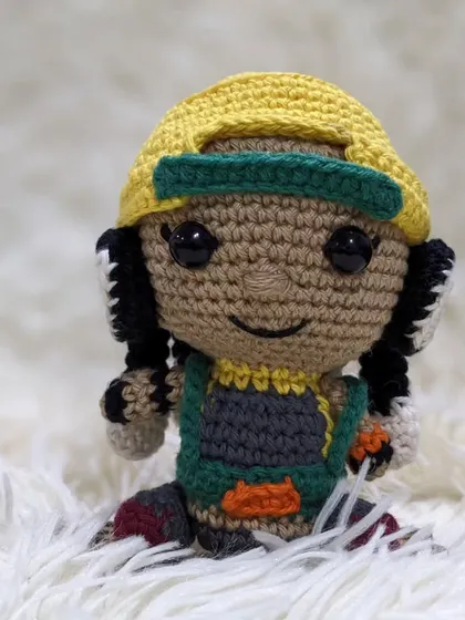 A full view of the amigurumi Raze doll sitting down.