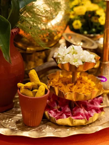A display of traditional Indian elements, including whole turmeric and fresh flowers. We believe in honouring the roots of our cuisine in every aspect of our presentation.
