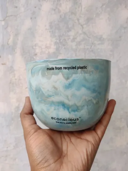 Held in hand, you can see the unique, ocean-like swirls of this blue and white recycled plastic pot. No two pieces are ever the same, making your gift truly one-of-a-kind.