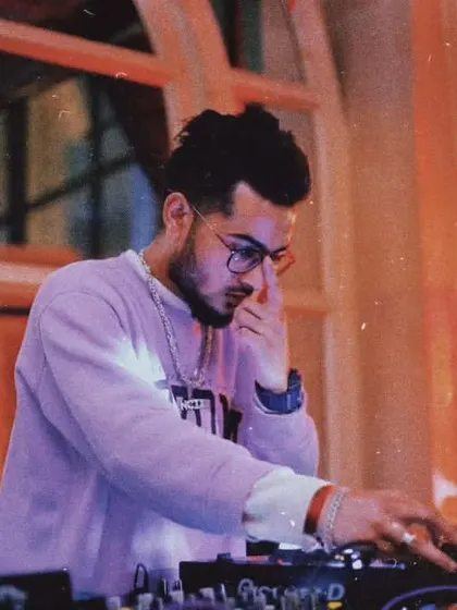 A focused shot of me at the decks, deep in thought while selecting the next track. Curating the right musical journey for the crowd is a craft I take seriously.