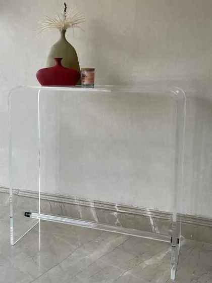 We designed this custom acrylic console for a client who wanted a light and dainty piece. The transparent material gives it a floating, minimal look that doesn't visually clutter the space, perfect for modern entryways or hallways.