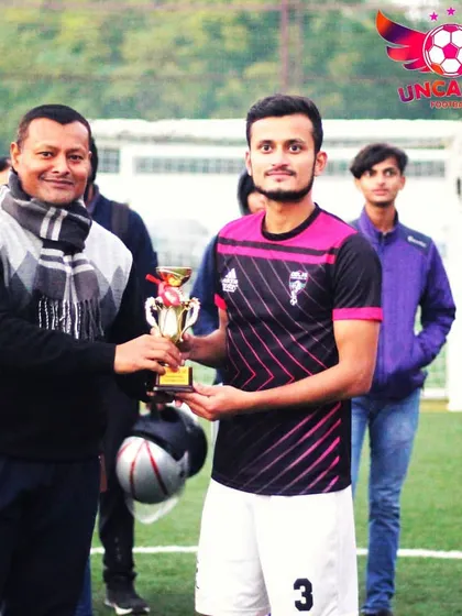A player from the runner-up team receives his trophy. I believe in recognizing the effort of all top performers, not just the final winners.