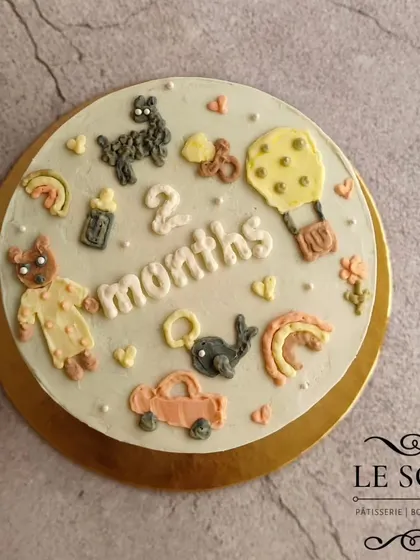 A cake to celebrate the two-month milestone. This one-pound Chocolate Caramel cake is decorated with tiny, hand-piped buttercream details like a teddy bear, a car, a rainbow, and a milk bottle.