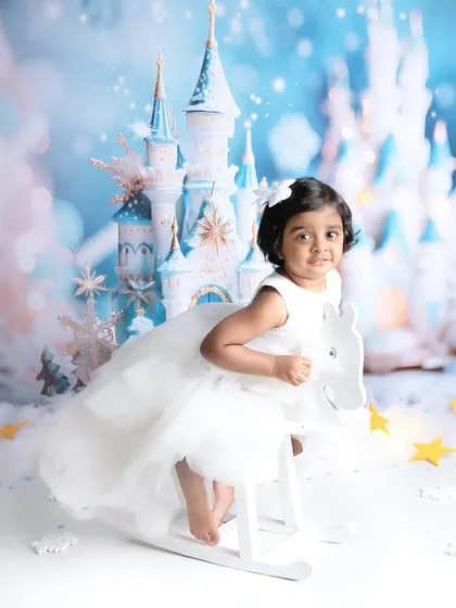 A winter wonderland fairytale. This little princess on her rocking horse in front of a magical ice castle is a perfect example of a dreamy, storybook-themed shoot.