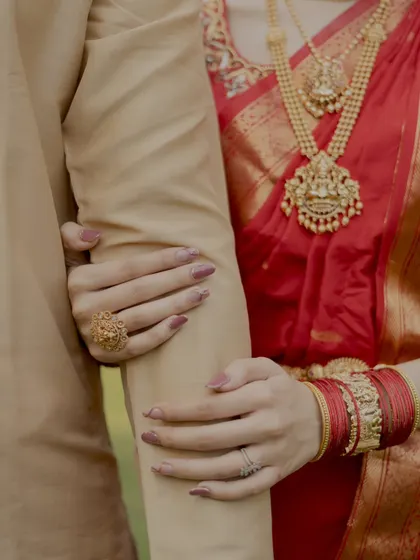 It's all in the details. This close up shot focuses on the bride's hands holding the groom's arm, a simple yet powerful symbol of their bond.