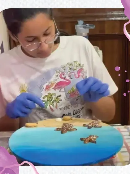 A close-up of a student creating a beautiful turtle-themed resin art piece. This workshop teaches kids how to safely work with resin, mix pigments, and create stunning, glossy ocean scapes.