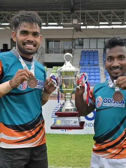 Two of our proud athletes, Ajit Hansdah and Suguda Majhi, with their bronze medals and the team trophy. Their success at the national level demonstrates the potential of grassroots talent.